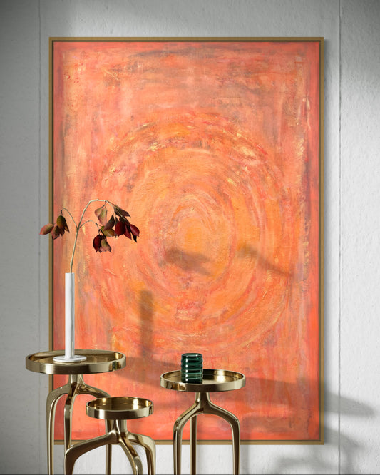 Abstract orange acrylic painting by Sisco Artworks on a gray wall with gold side tables and decor items.